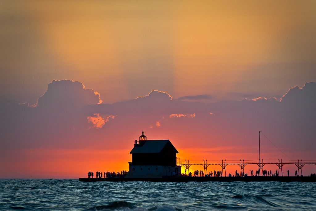 Grand Haven Lighthouse At Sunset. Photo Credit: Bob Peskorse